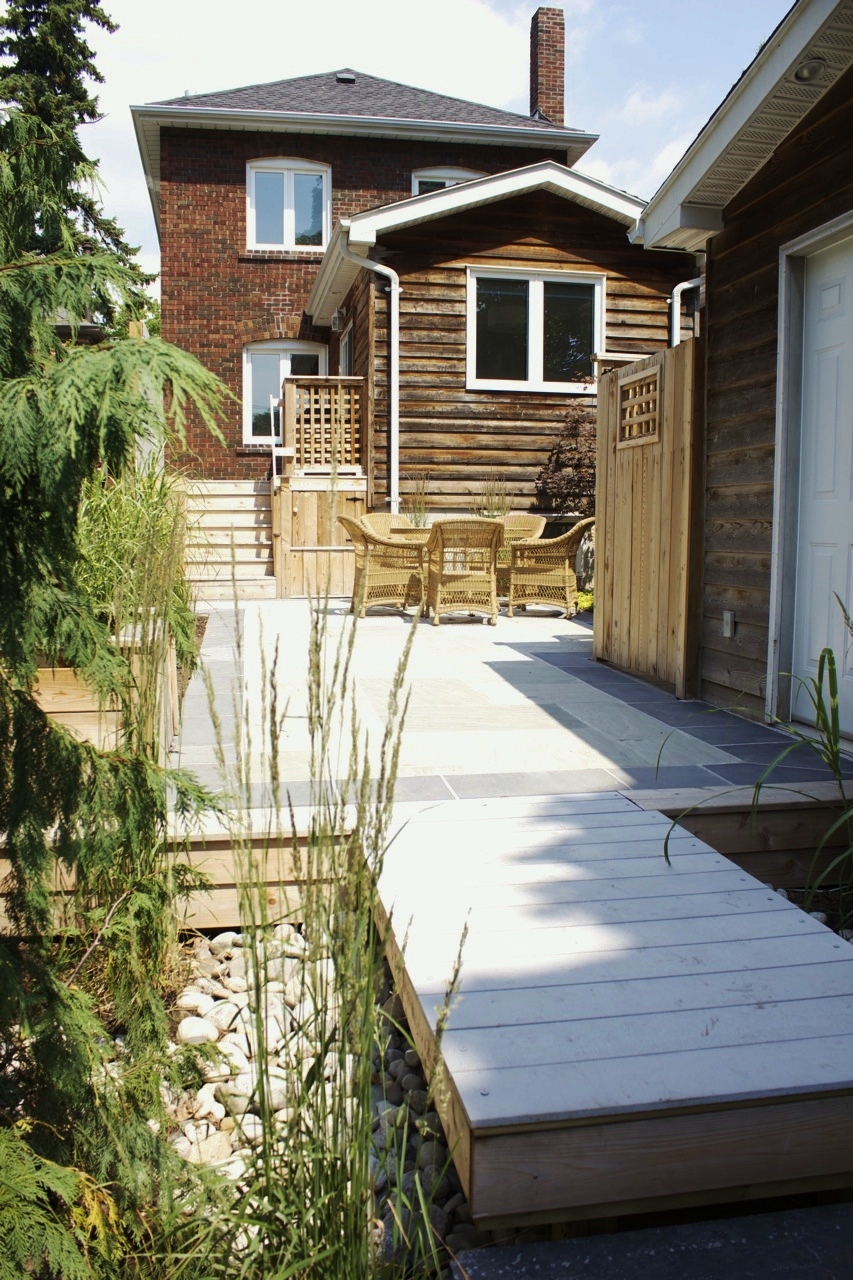 Backyard view showcasing stone walking area and dining area