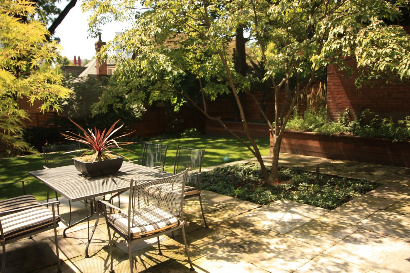 stone patio with seating area to join the sun and beautifully built backyard
