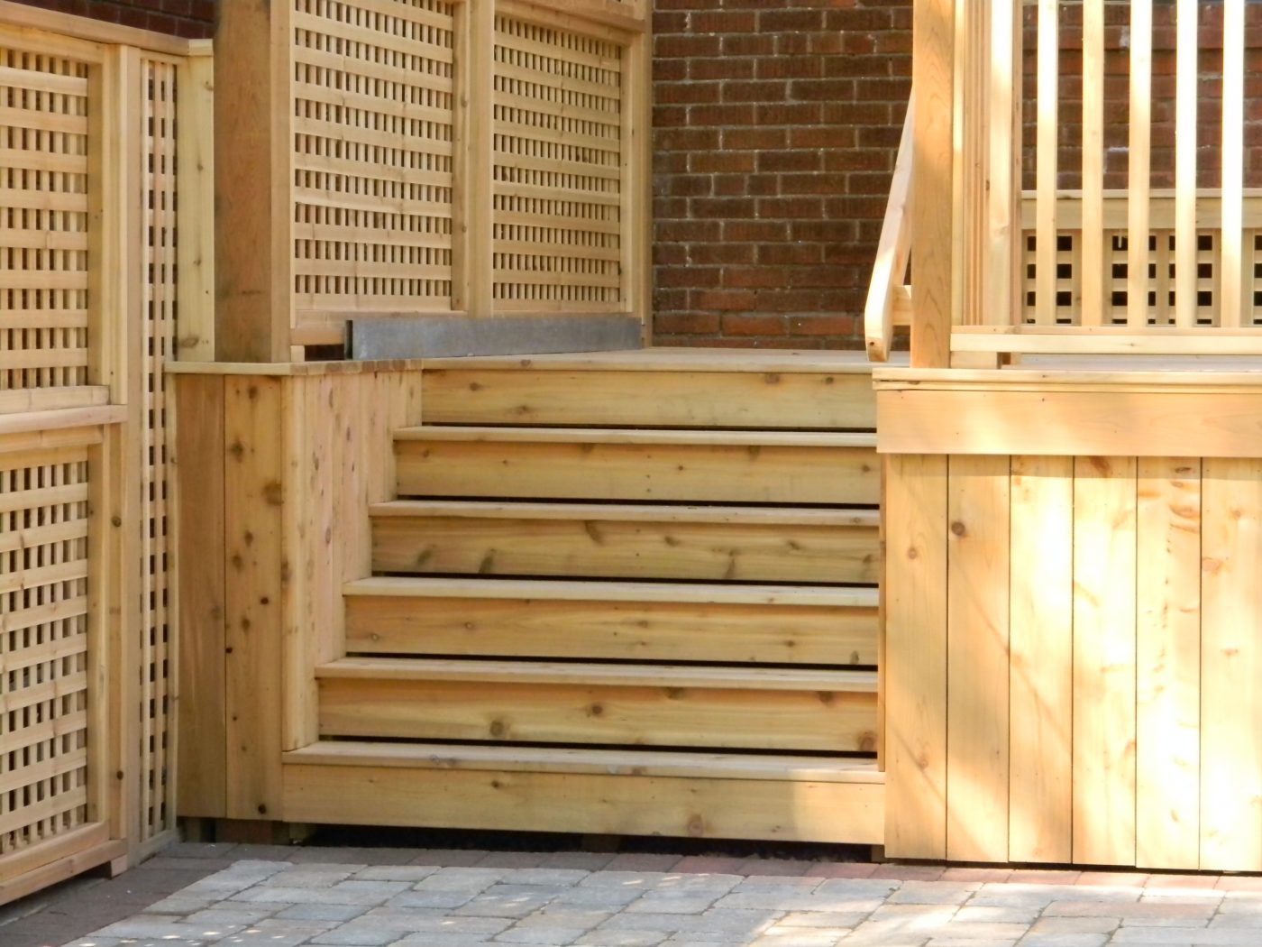 custom built wood deck with stairs and lattice built into the side for plant growth