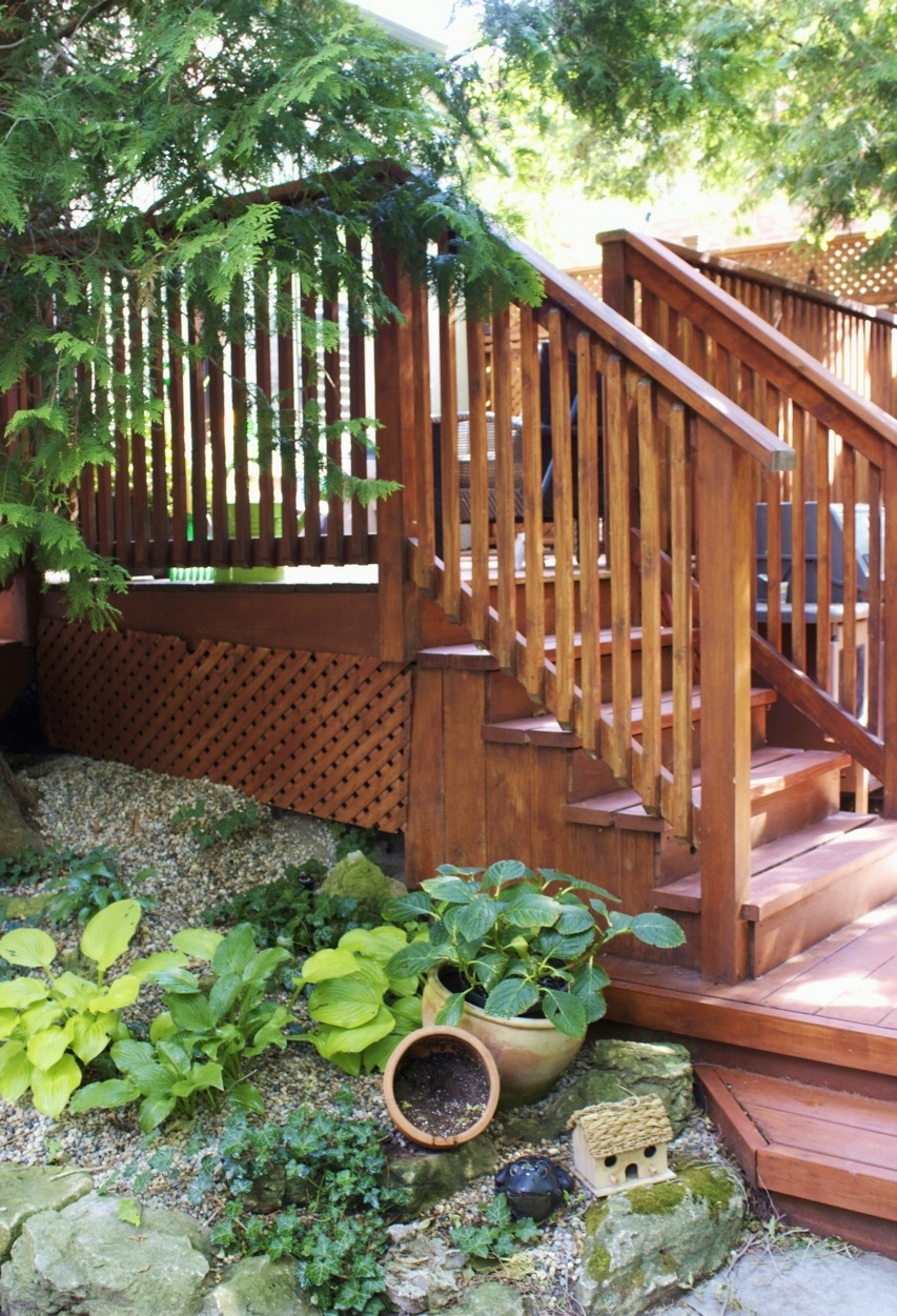 wood steps with natural stone pea gravel garden containing perrenials