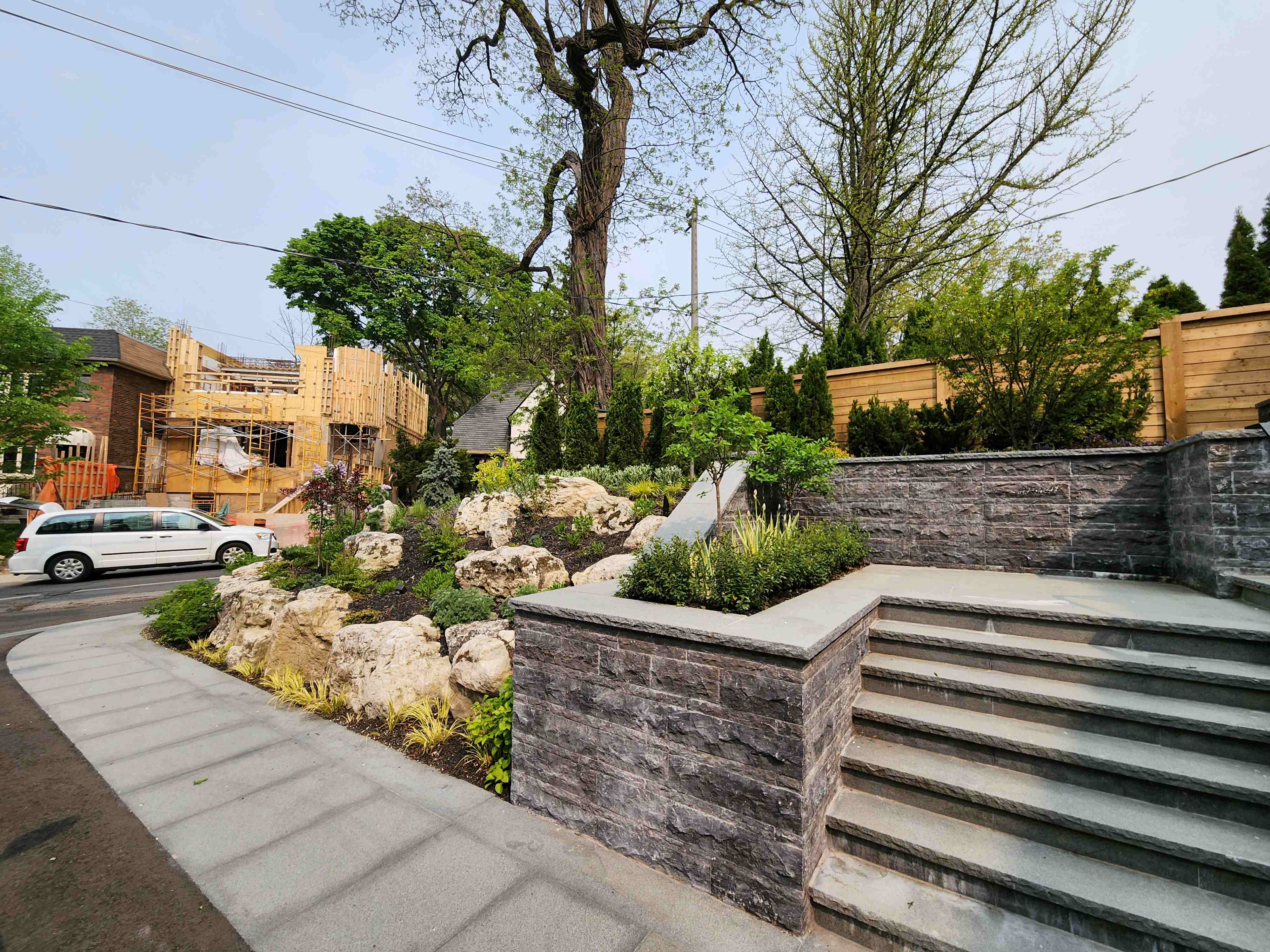 Angle of natural gardens meshed with retaining wall walkway creates stunning visual