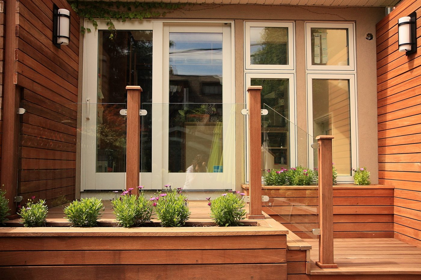 wood deck with glass panel guard rails with retaining wall flower boxes