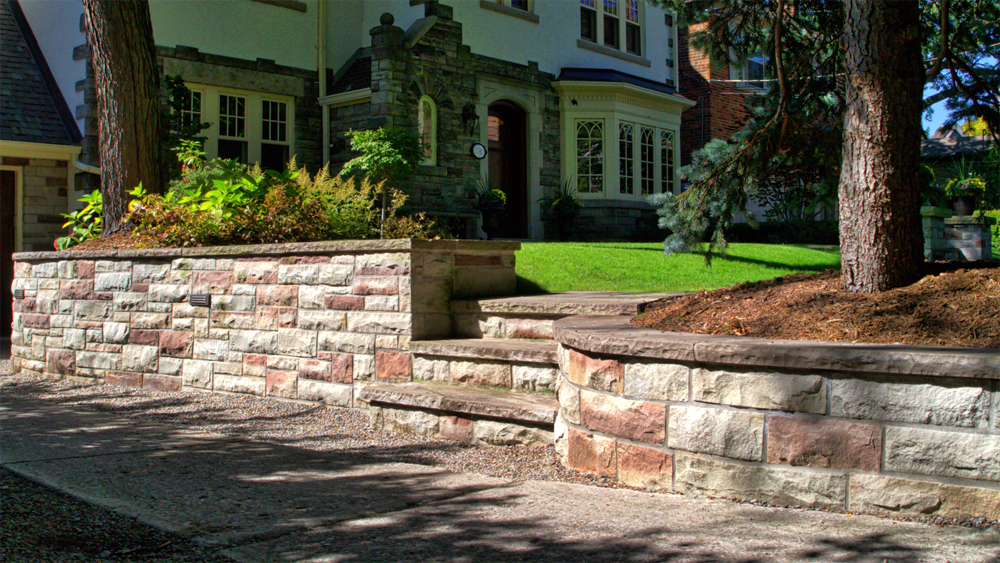Traditional Stone wall separating front walk and driveway