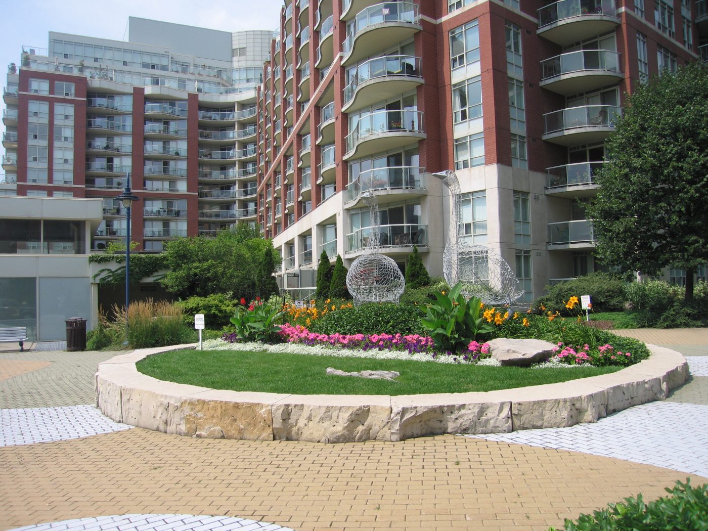 Natural stone with lawn space and gardens built into goose statue area