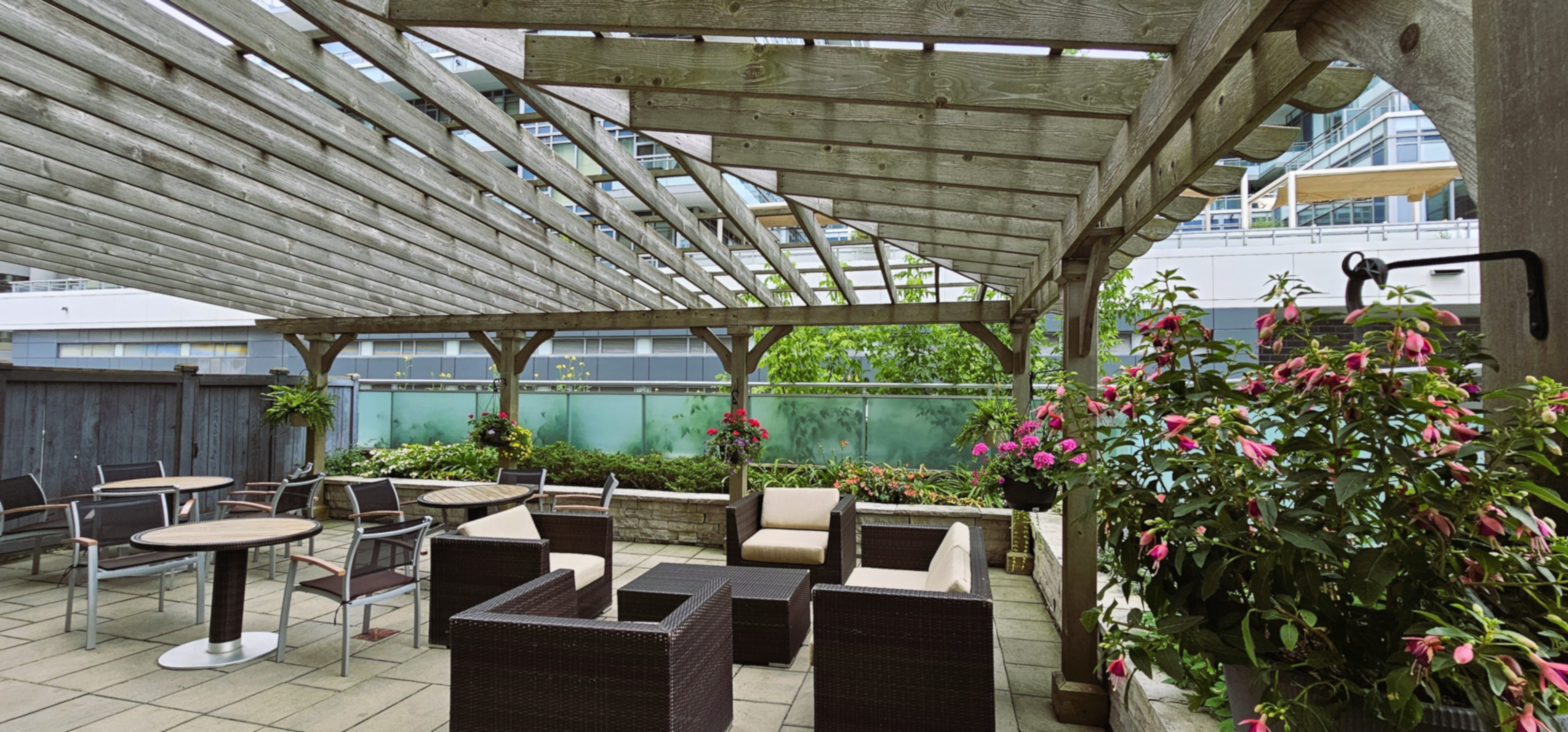 Upper rooftop patio seating area with white hydrangeas 